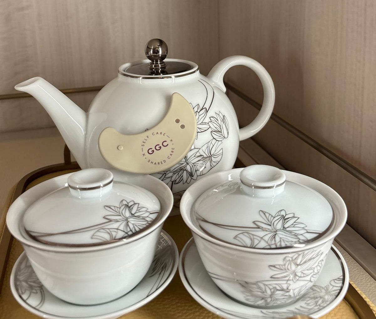 GGC Targeted LED Patch resting against a floral teapot behind two covered teacups
