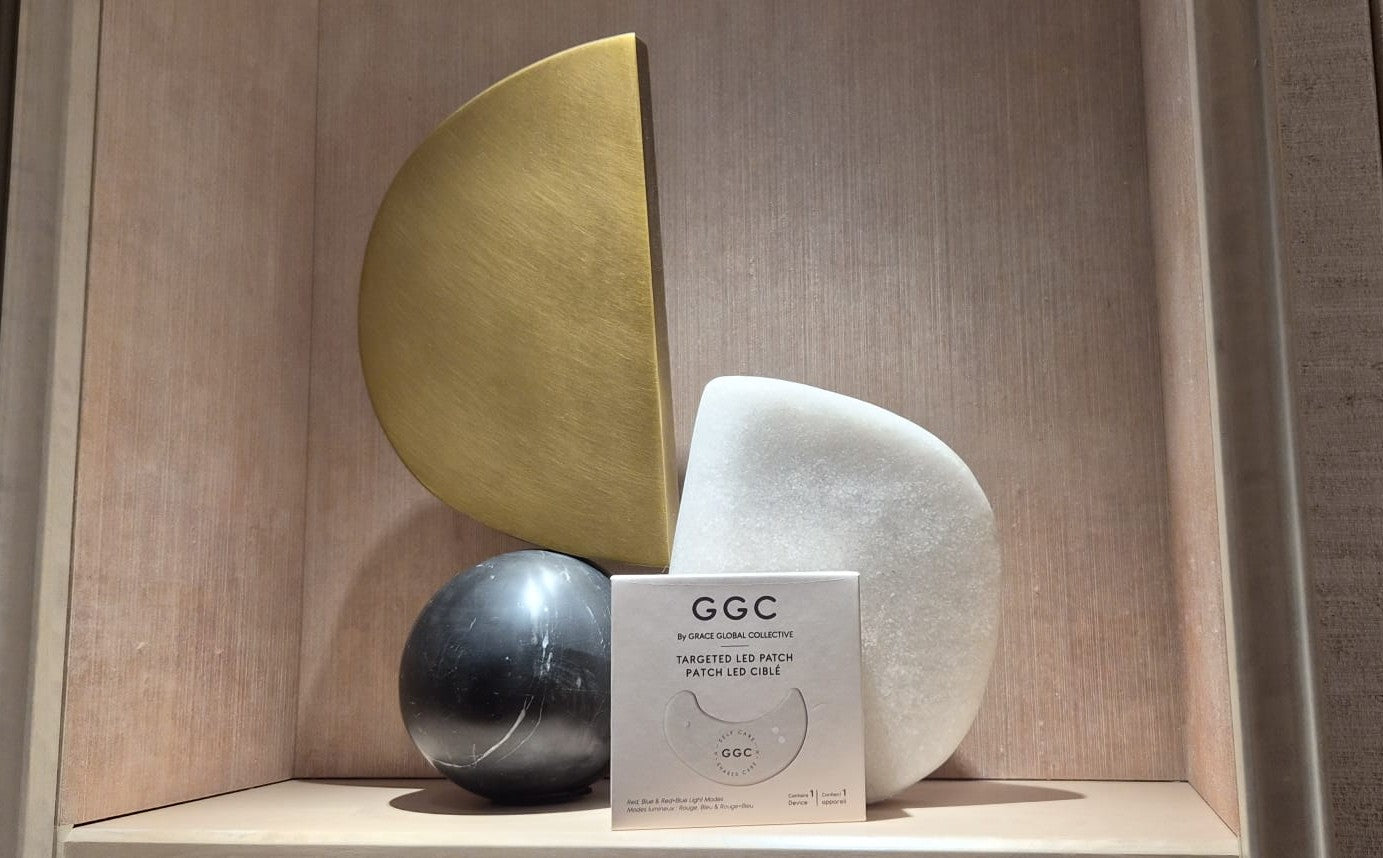 GGC packaging with gold, white and dark stone sculptures