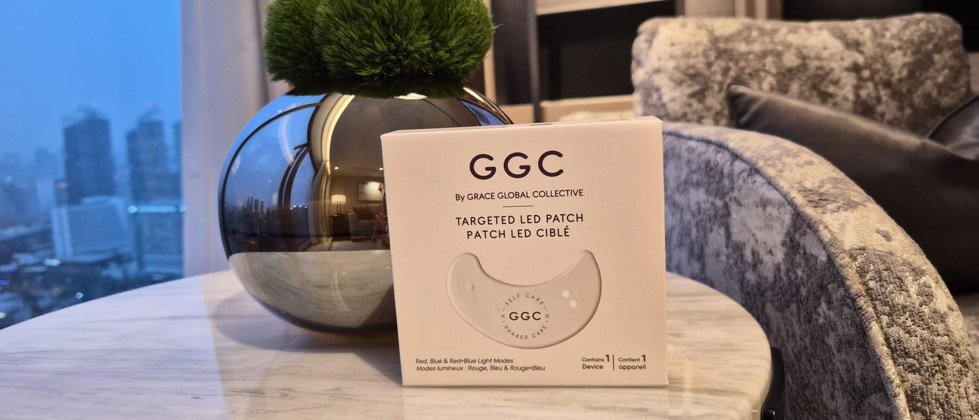GGC packaging on a marble side table beside a reflective vase
