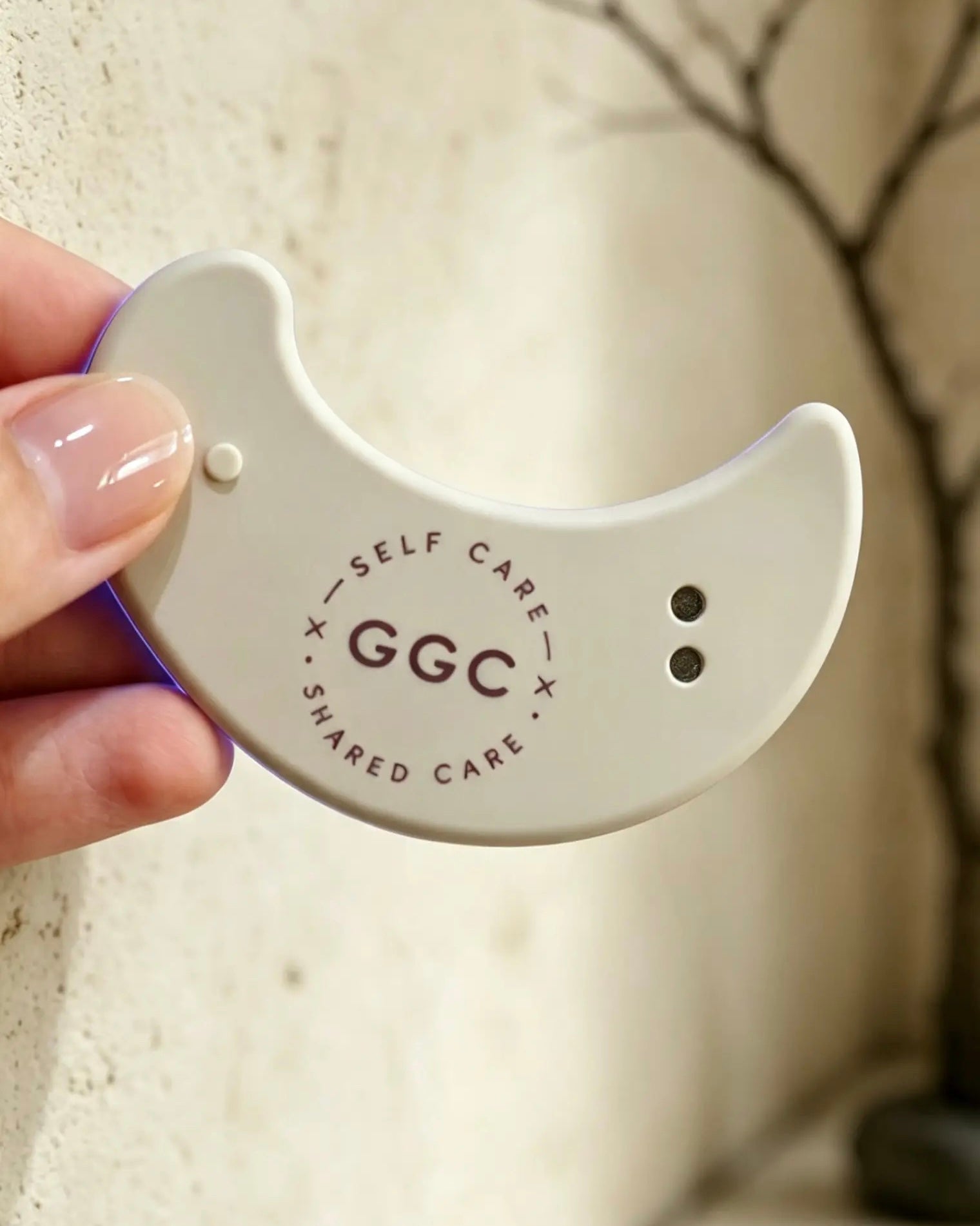 GGC Targeted LED Patch held in a hand against a warm textured background